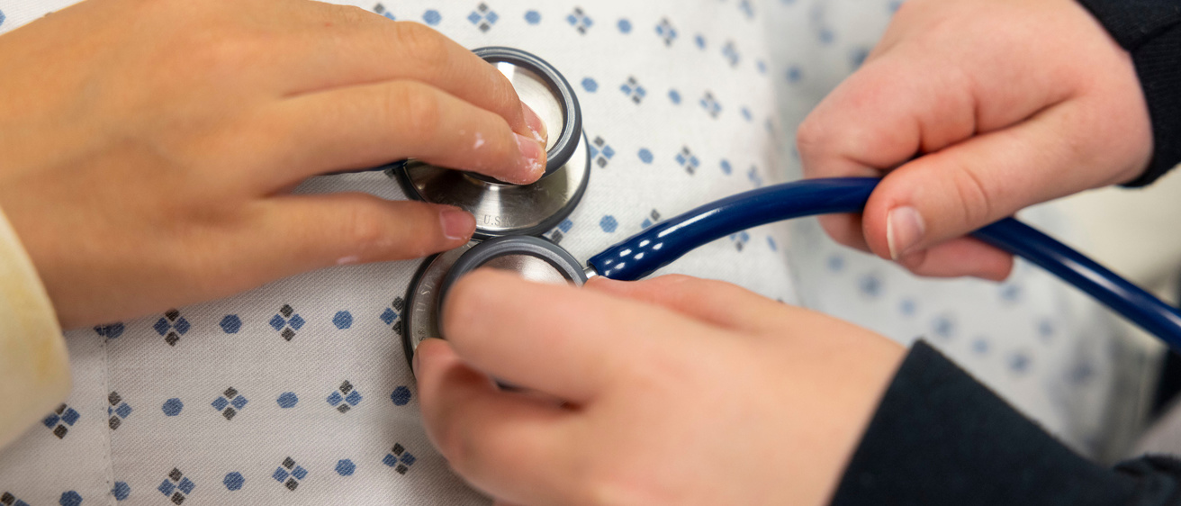 checking heart of patient