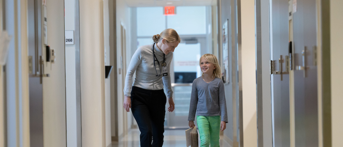 Family Medicine Scott blvd doctor and child walk down hallway